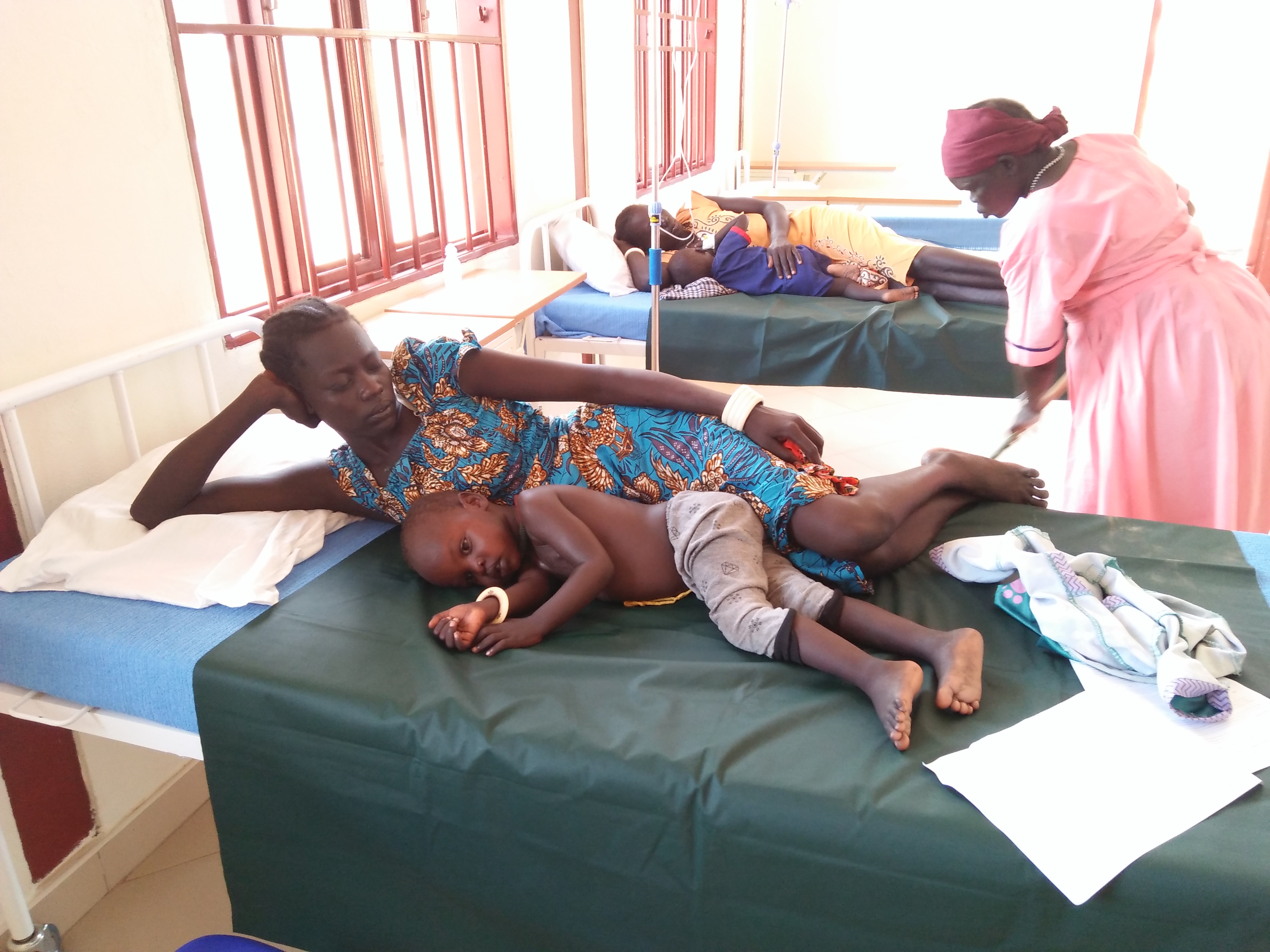 Kleine Malariapatienten, umsorgt von ihren Müttern, erhalten hier ab jetzt ebenso Hilfe wie alle anderen Kranken, die in ihrer Not die Gesundheitsstation aufsuchen.