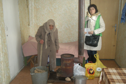 In ihrer Unterkunft ist es so kalt, dass Maryam Avagyan den ganzen Tag ihren Mantel trägt. Hoffnungszeichen-Mitarbeiterin Aljona Zeytunyan überbringt ihr wichtige Lebensmittel.
