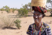 Guoshumo Lokuleu (51) ist jeden Tag viele Stunden unterwegs, um ihre Familie mit Wasser zu versorgen. 10 Liter passen in den Kanister, den sie auf dem Kopf trägt. 