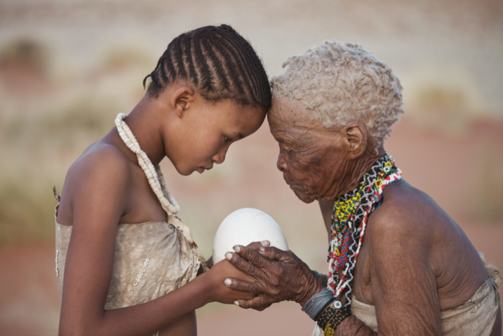 A young and an old woman stand head to head